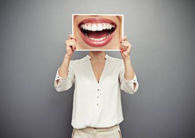 woman holding picture with big smile