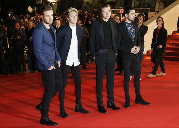 Members of British band One Direction (LtoR) Liam Payne, Niall Horan, Louis Tomlinson and Zayn Malik pose upon their arrival at the Palais des Festivals to attend the 16th Annual NRJ Music Awards on December 13, 2014 in Cannes, southeastern France.  AFP PHOTO / VALERY HACHE        (Photo credit should read VALERY HACHE/AFP/Getty Images)