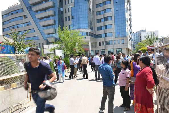 Nepalese people stand in the streets as a 7.4 magnitude earthquake hits the country, in Kathmandu on May 12, 2015.   A 7.4-magnitude earthquake hit devastated Nepal, sending terrified residents running into the streets in the capital Kathmandu, according to witnesses and the US Geological Survey.  The quake struck at 12:35pm local time in the Himalayan nation some 83 kilometres (52 miles) east of Kathmandu, more than two weeks after a 7.8-magnitude quake which killed more than 8,000 people.   AFP PHOTO / PRAKASH MATHEMA        (Photo credit should read PRAKASH MATHEMA/AFP/Getty Images)