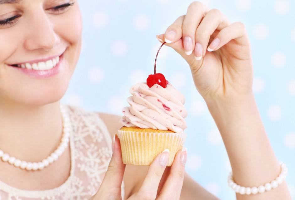 Woman eating a cupcake