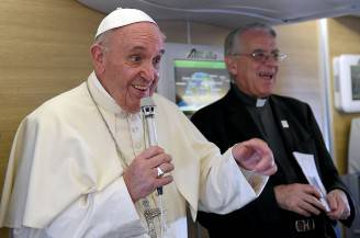 Pope Francis addresses journalists in the flight back to Rome after a six-day visit in Africa on November 30, 2015. Pope Francis traveled to Kenya, Uganda and the Central African Republic. AFP PHOTO / POOL / DANIEL DAL ZENNARO / AFP / POOL / DANIEL DAL ZENNARO AND GIUSEPPE CACACE (Photo credit should read DANIEL DAL ZENNARO,GIUSEPPE CACACE/AFP/Getty Images)