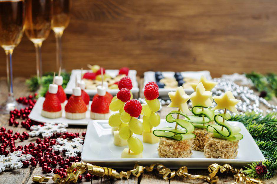 Assortment of New Year's snacks and a glass of champagne. toning. selective focus