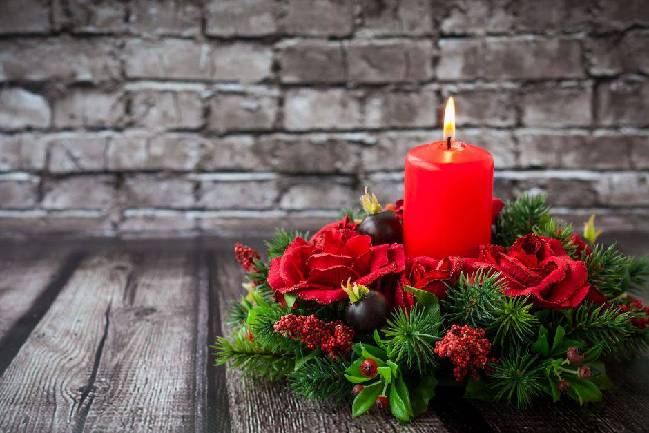Christmas table decoration with burning red candle