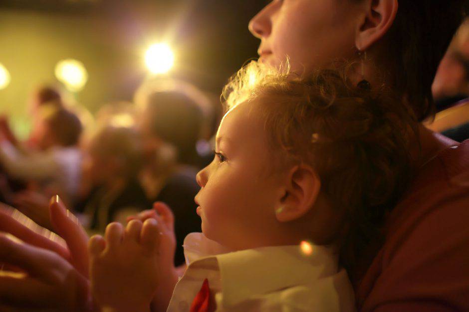 Toddler with mother enjoying time in the theater
