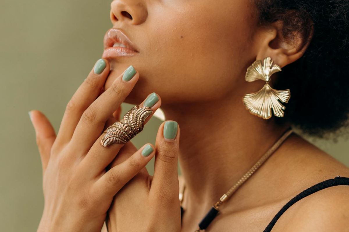 Una ragazza che mostra le mani con smalto verde