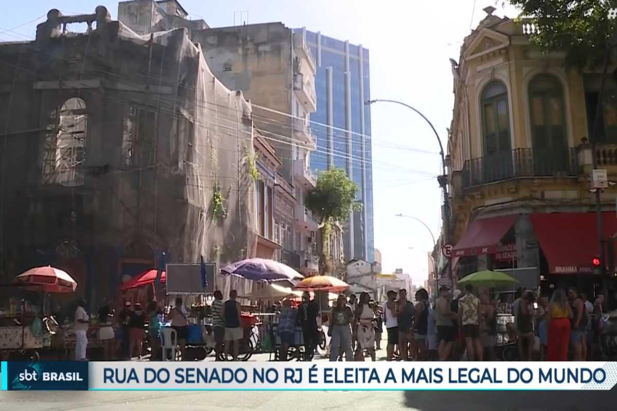 Una via di Rio De Janeiro con tante persone e macchina